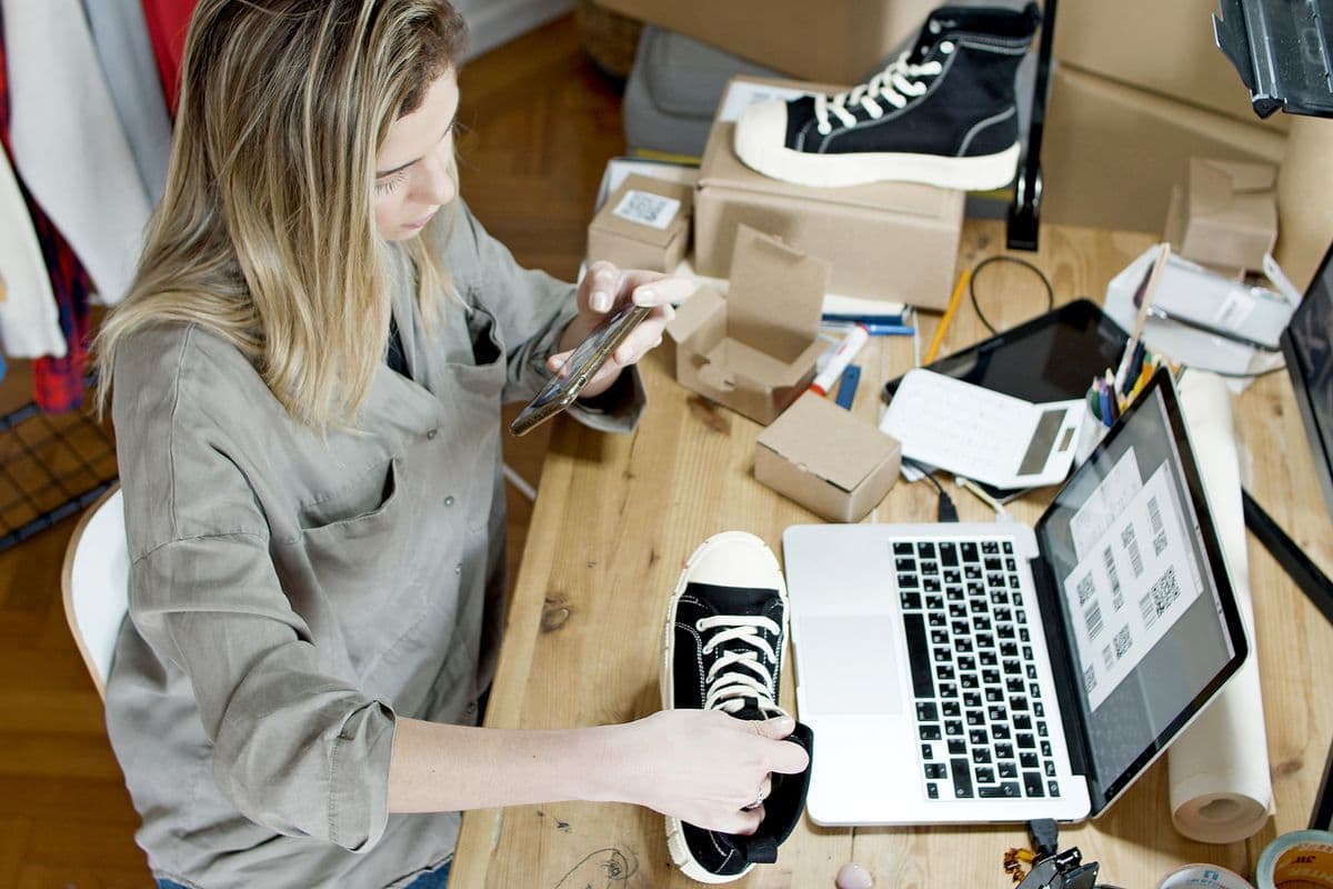 A seller photographing a product to list in her online store