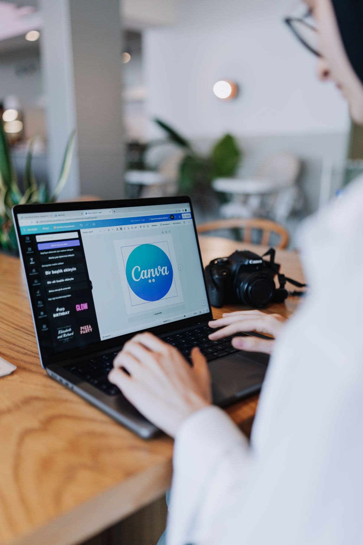 A woman designing her store's branding on a laptop